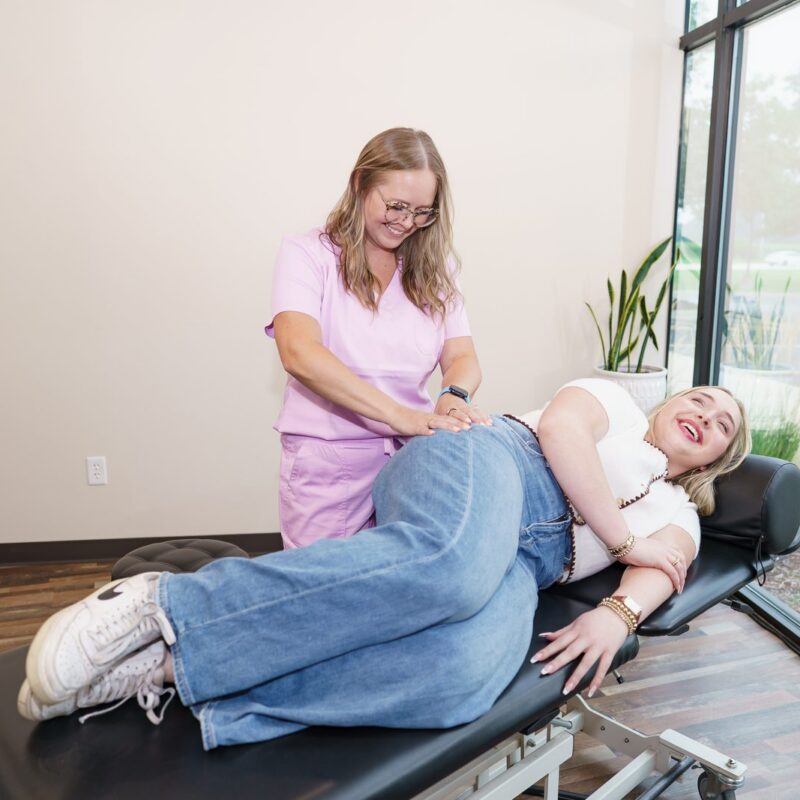 Dr. Brittany Dempsey treating a patient's low back at CMR Health Group in Yorkville, IL