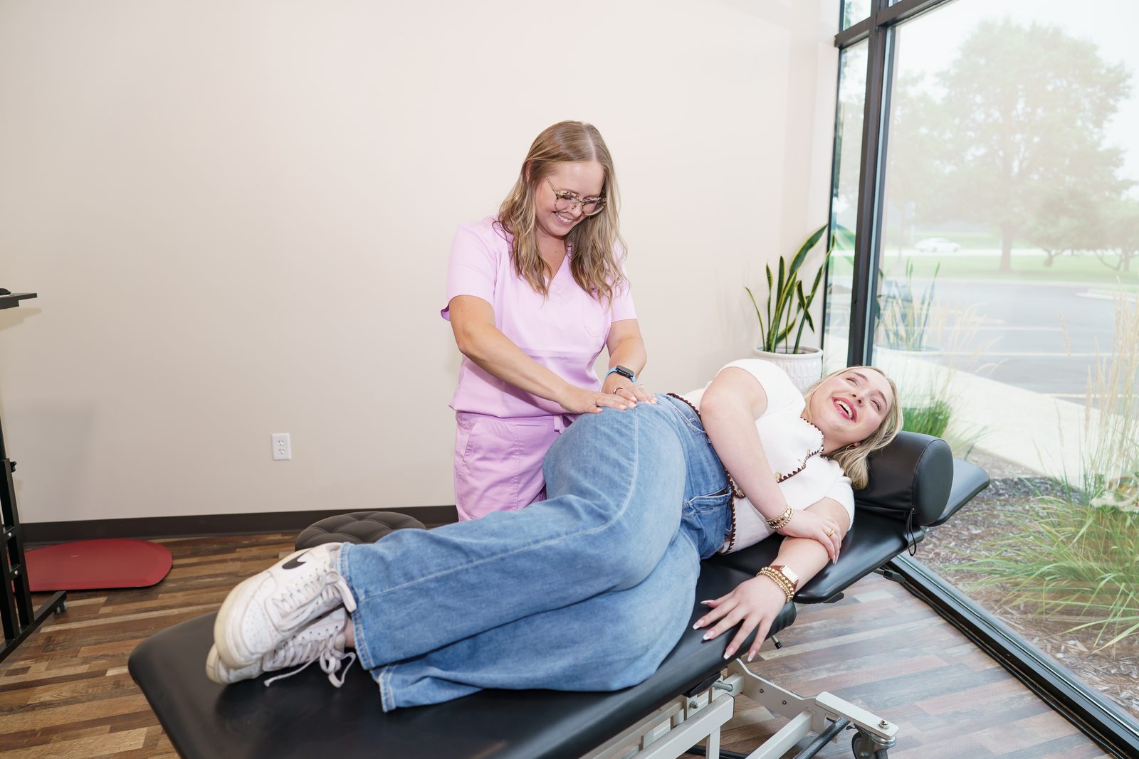 Dr. Brittany Dempsey treating a patient's low back at CMR Health Group in Yorkville, IL